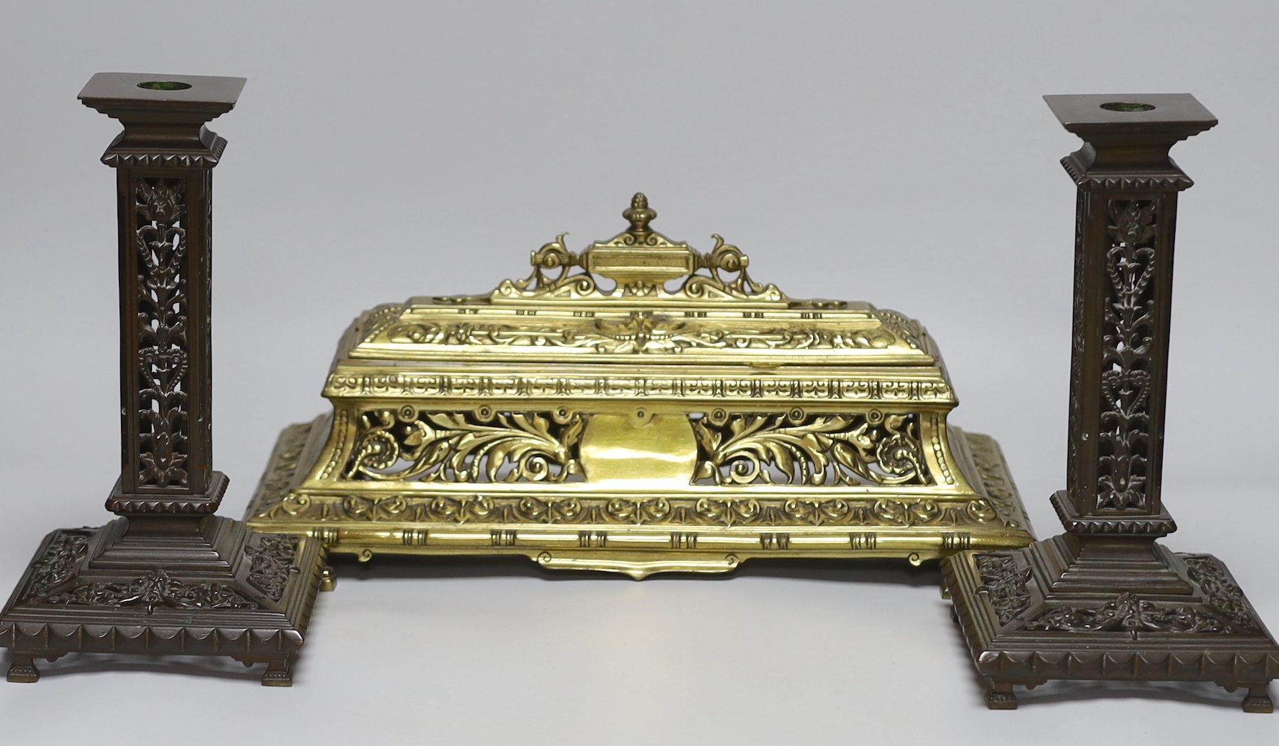 A Victorian cast brass pen and inkstand and a pair of cast brass candlesticks (3) 24.5cm tall